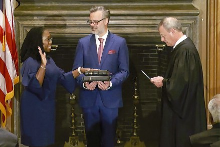 In this image from video provided by the Supreme Court, Chief Justice of the United States John Roberts administers the Constitutional Oath to Ketanji Brown Jackson as her husband Patrick Jackson holds the Bible at the Supreme Court in Washington
Supreme Court Jackson, Washington, United States - 30 Jun 2022